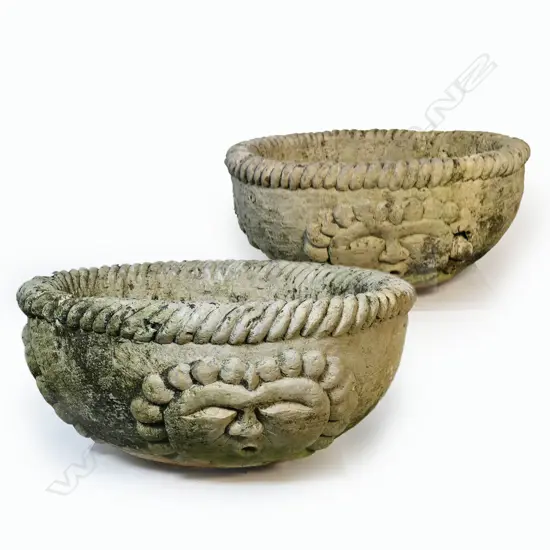 A pair of very large old concrete planters,