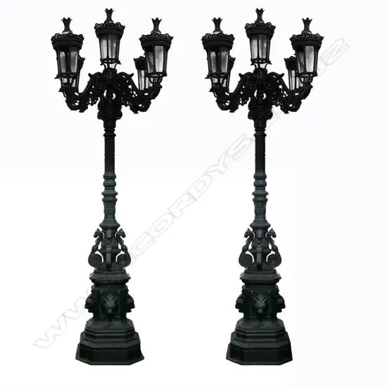 A pair of tall antique style cast iron lamp standards,