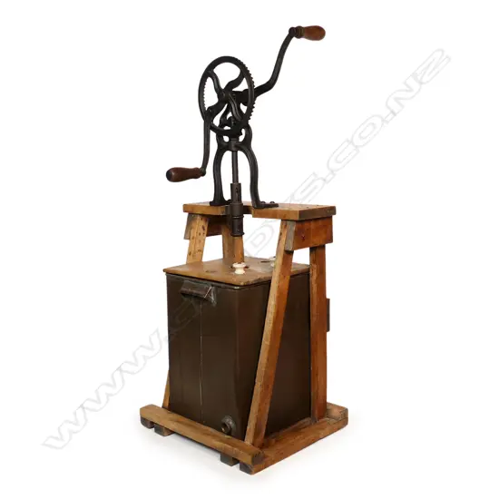 A 1908 floor standing butter churn,