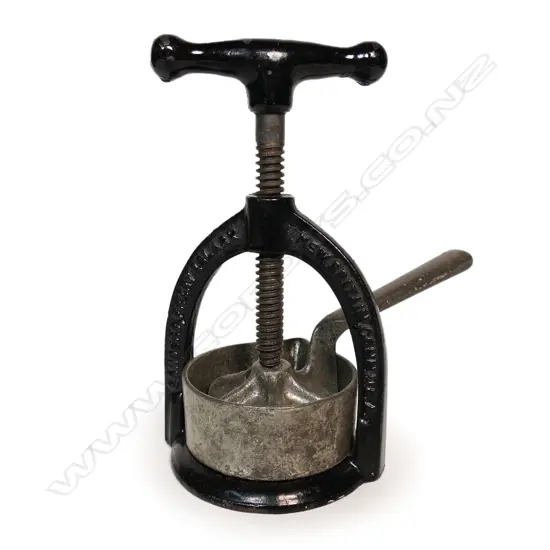 An 1884 Landers Frary & Clark USA meat and juice juice press,