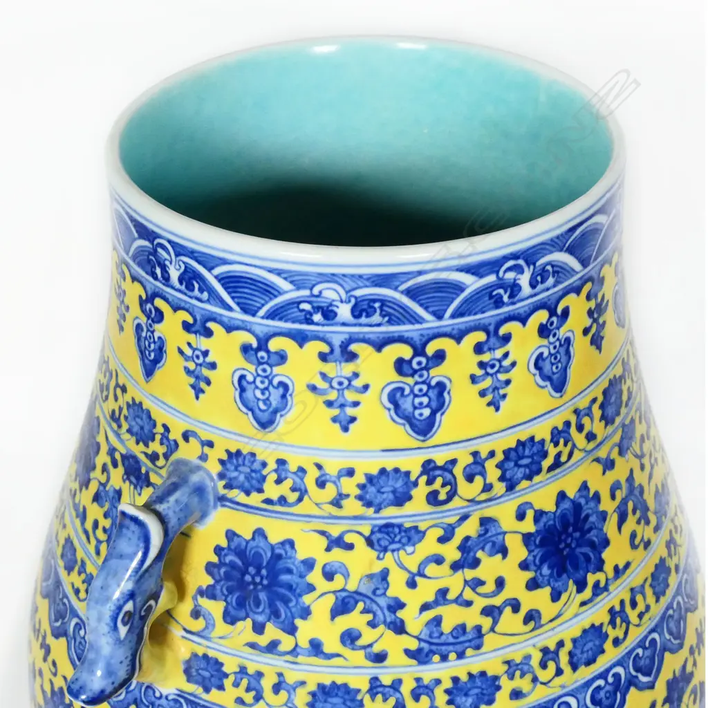 A large Chinese porcelain vase - round spreading foot, bulbous ovoid form, blue trailing flowering vines on a mustard yellow ground, shoulder handles in the form of mythical beast heads, glazed turquoise interior. H.370mm. Image 1++