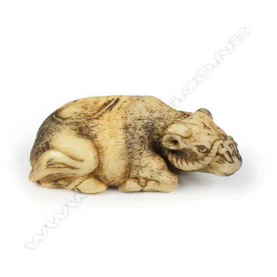 An antique carved antler netsuke,