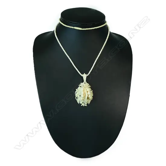 A vintage carved ivory locket,