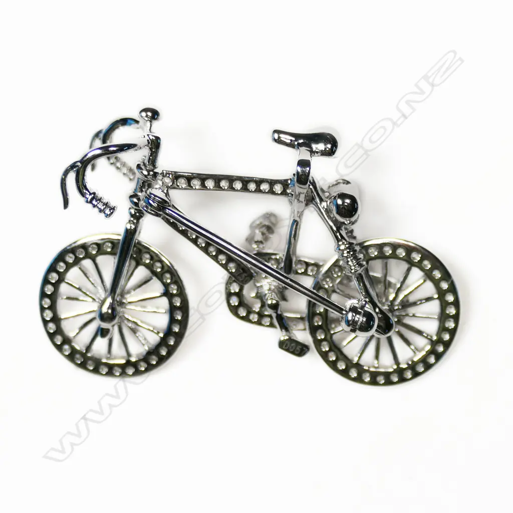 An 18ct white gold and diamond bicycle brooch Image 1++