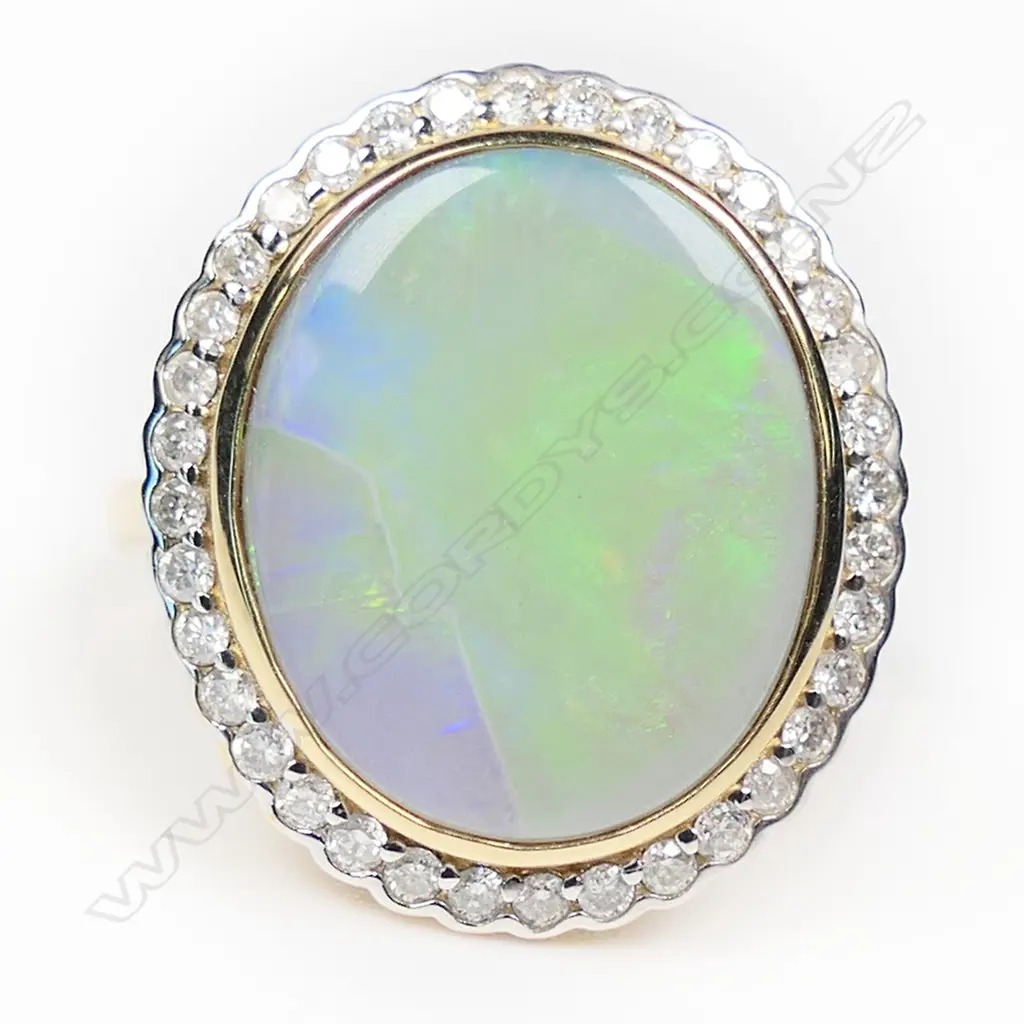 A 14ct white gold opal and diamond halo ring, Image 1++