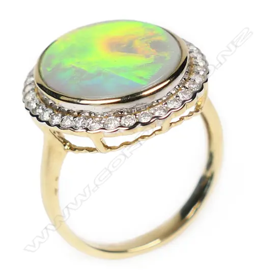 A 14ct white gold opal and diamond halo ring,