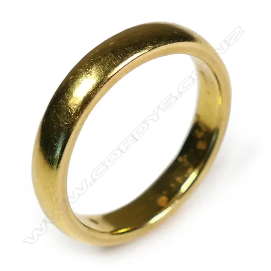 An old 24ct yellow gold plain band ring,