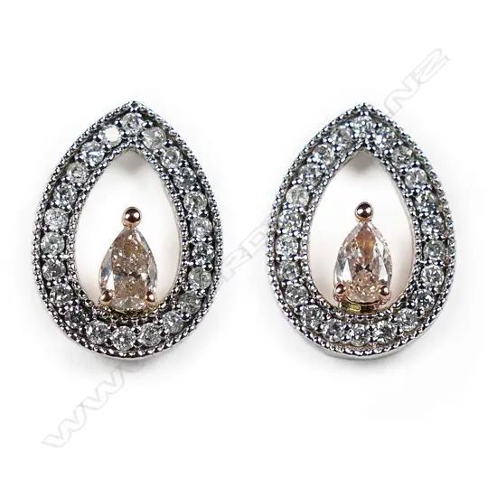 A pair of 14ct white gold pink diamond halo stud earrings,