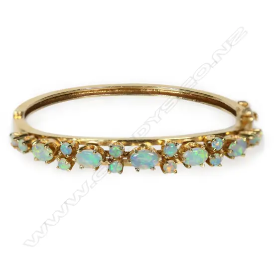 A 14ct gold and opal Edwardian style hinged bangle,