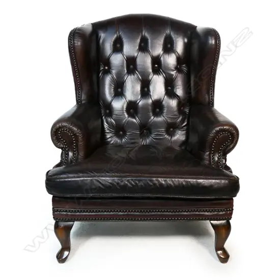An antique style leather wing back chair,