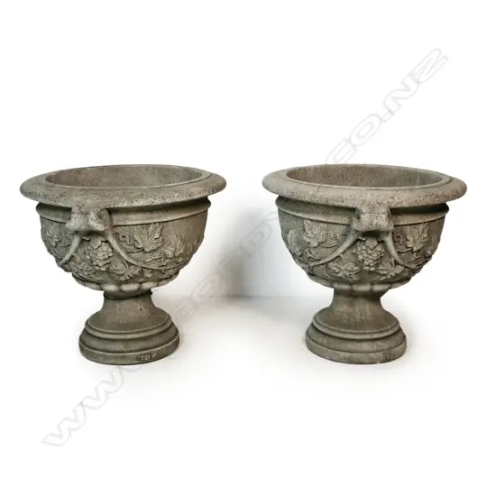 A pair of large classical concrete garden pedestal urns,