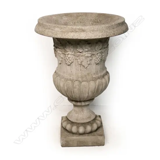 A classical concrete garden pedestal urn,