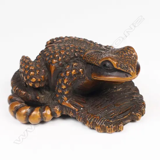 A late 19thC wood netsuke, study of a toad,