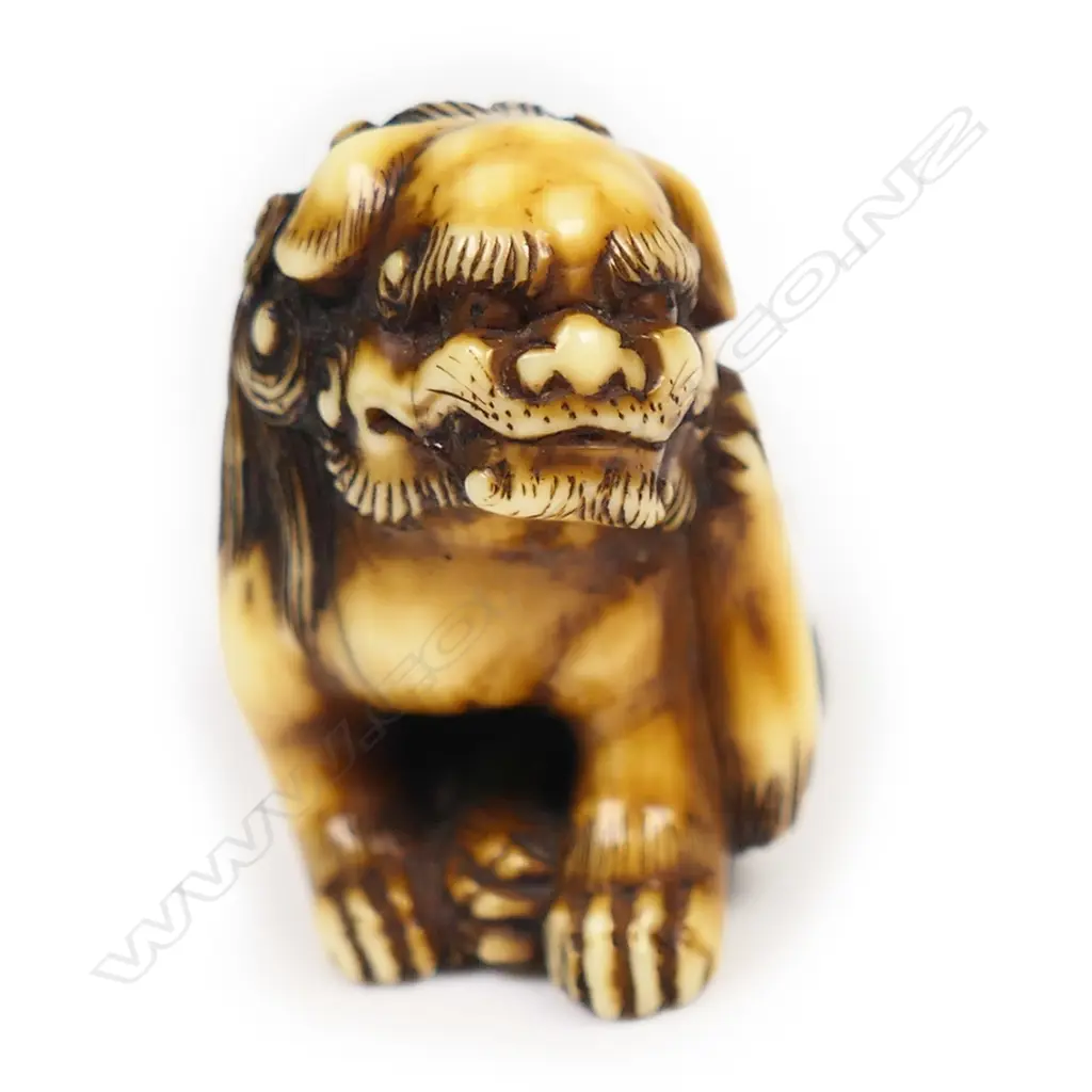 A 19thC ivory netsuke study of a seated shishi, Image 1++