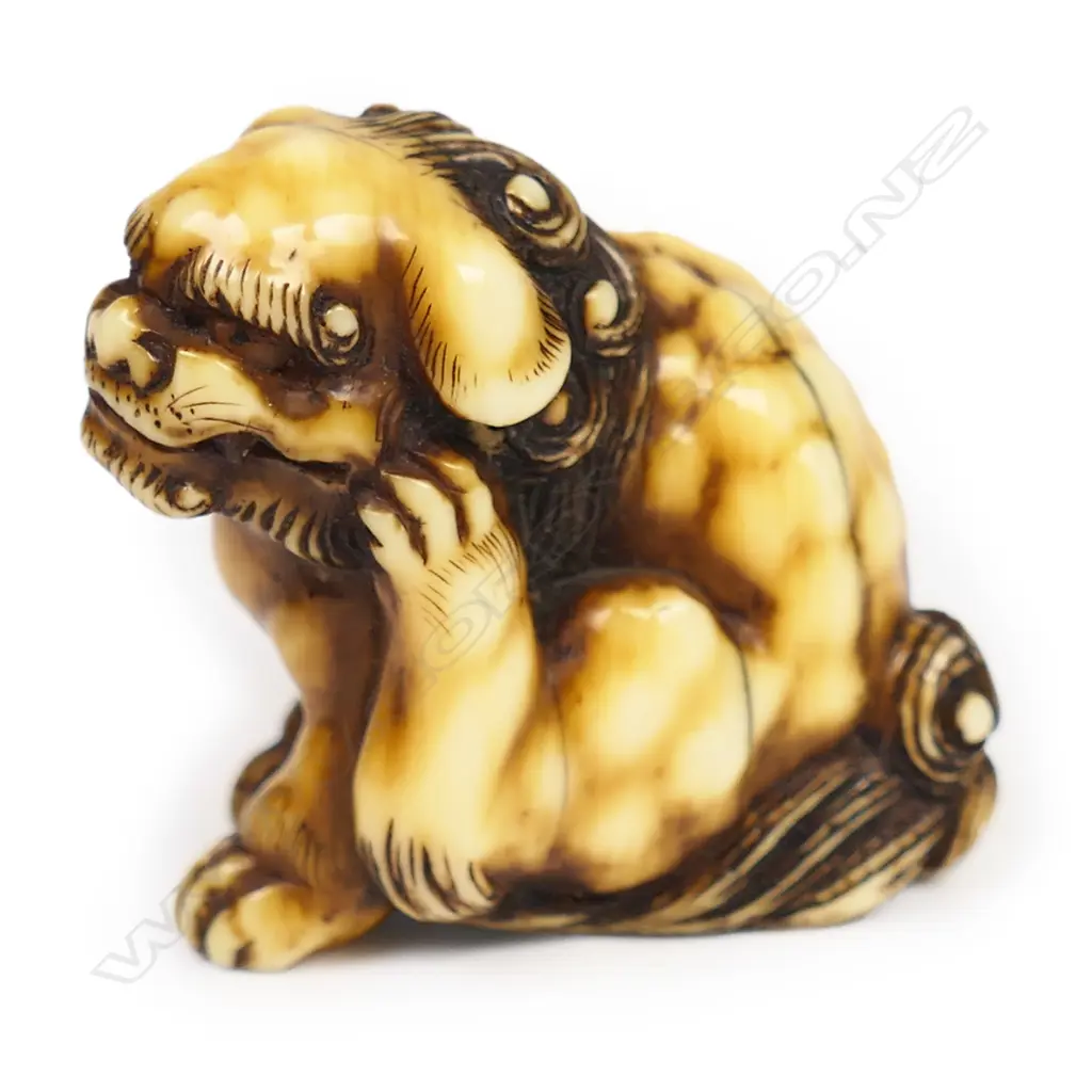 A 19thC ivory netsuke study of a seated shishi, Image 1++