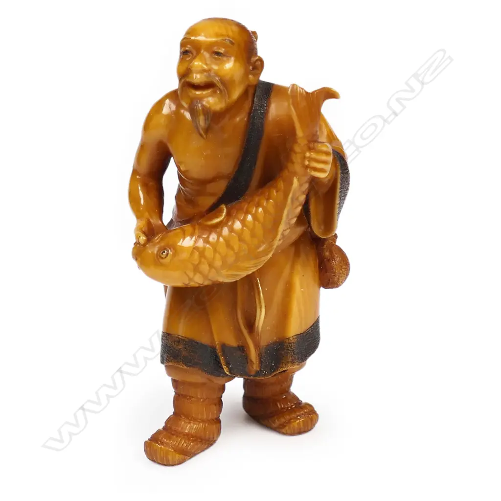 An old stained ivory netsuke of a fisherman, Image 1++