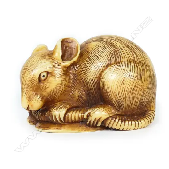 An ivory netsuke study of mouse lying on a fan,