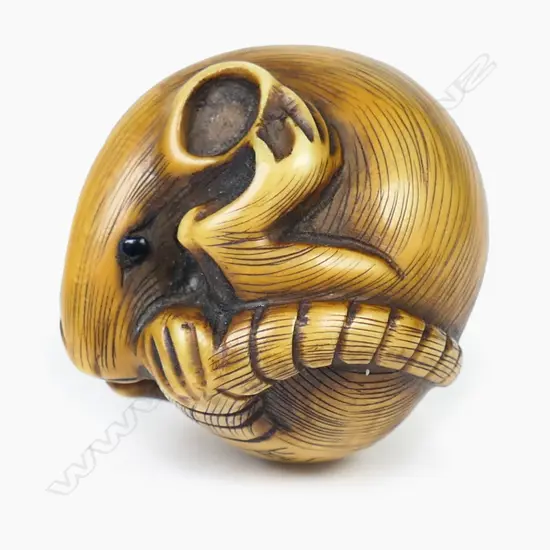 An ivory netsuke study of a contorted mouse,