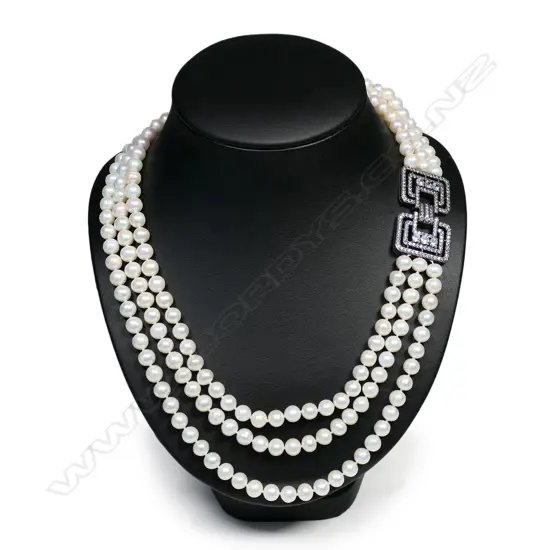 A triple strand cultured pearl necklace,