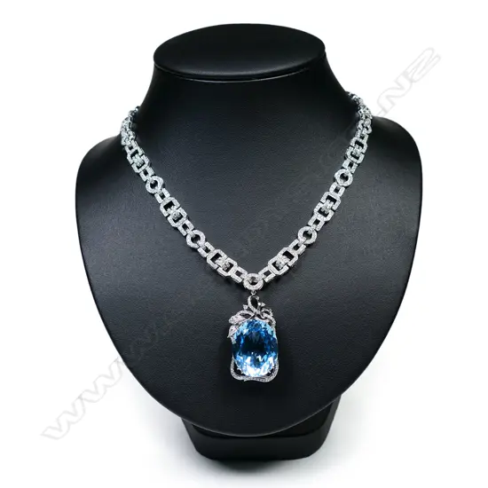 An 18ct white gold blue topaz and diamond pendant necklace,