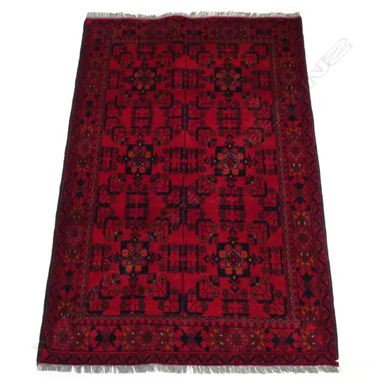 A hand knotted Andkhoy rug the field decorated with geometric and floral patterns, multiple border guards. 2000 x 1250mm.