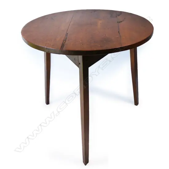 An antique pine cricket table,