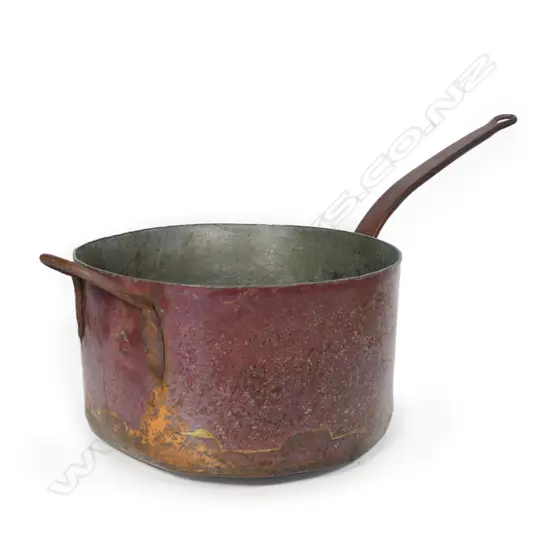 A large and heavy copper candy pan,