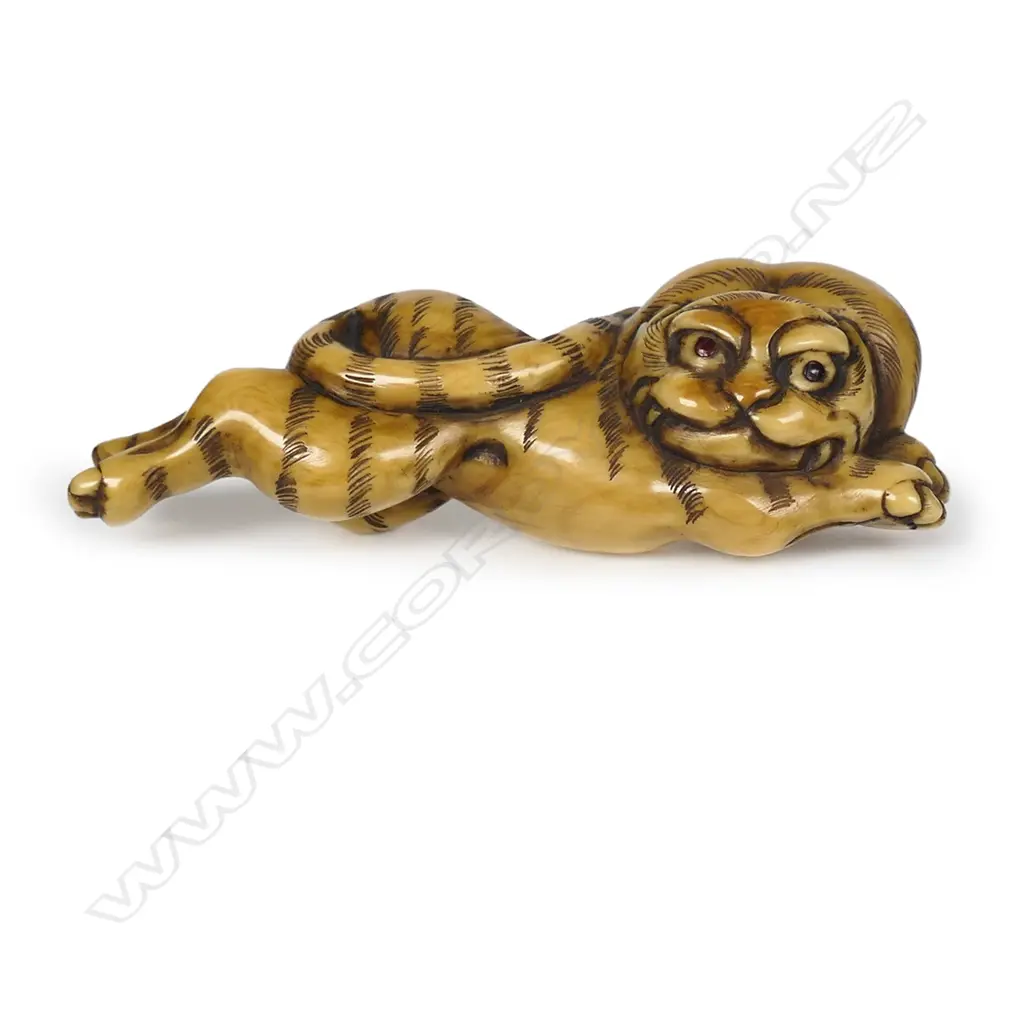 An ivory netsuke of a recumbent stretching tiger, Image 1++