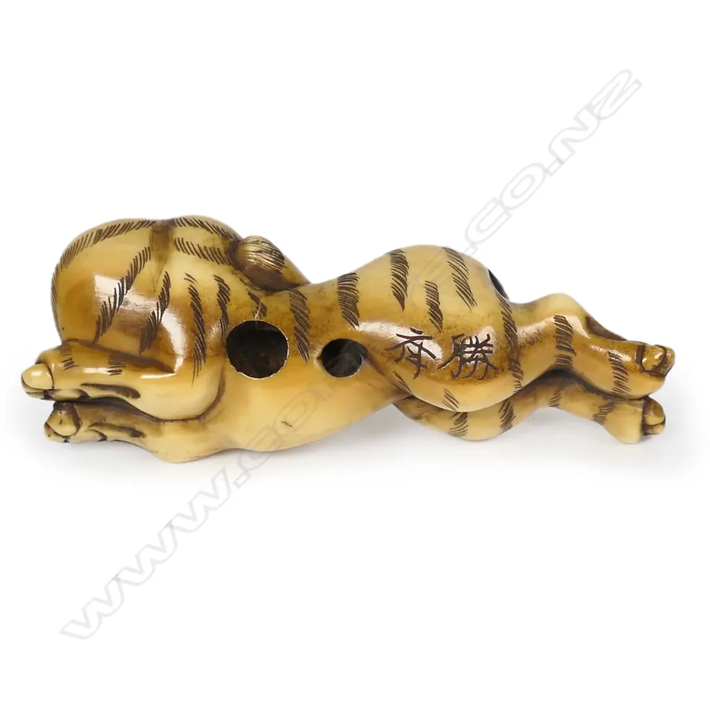 An ivory netsuke of a recumbent stretching tiger, Image 1++
