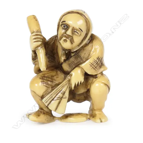 An ivory netsuke of an old figure,