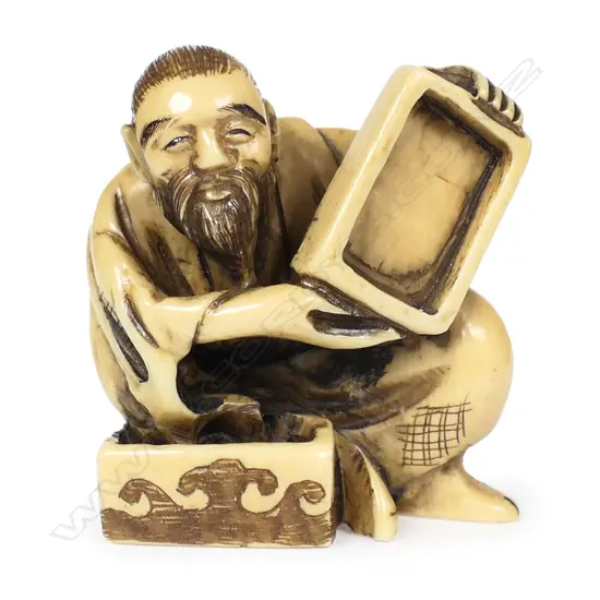An ivory netsuke modelled as a box maker,