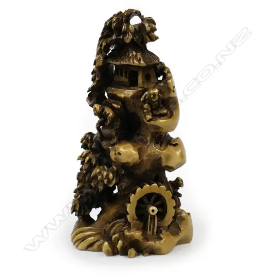 Ivory netsuke of a mountainous village scene,