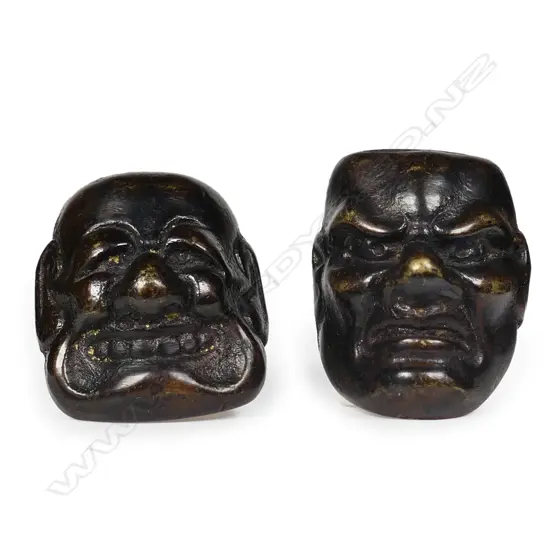 Two old cast iron netsuke as Noh masks,