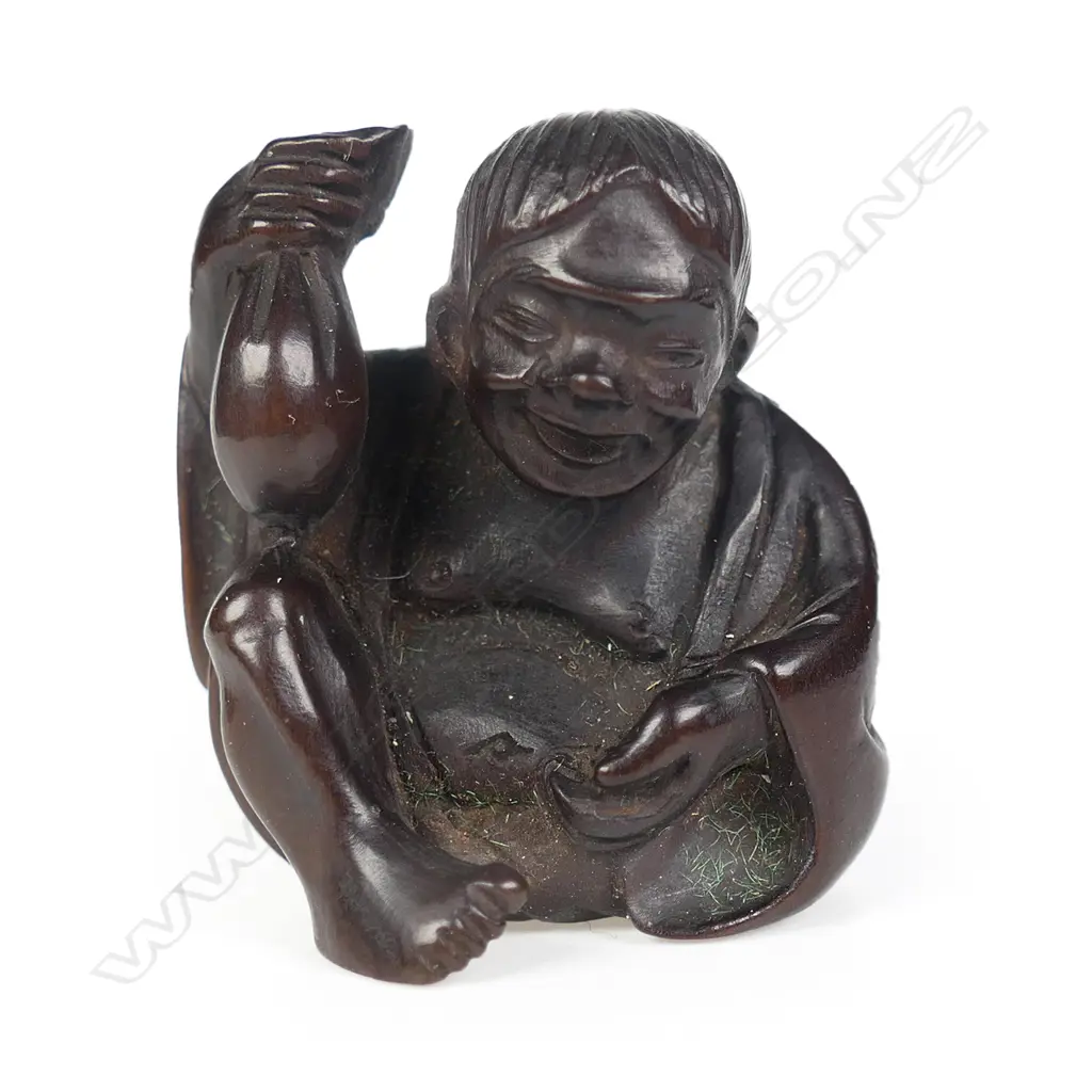 An old carved dark wood netsuke of a drunken shojo, Image 1++