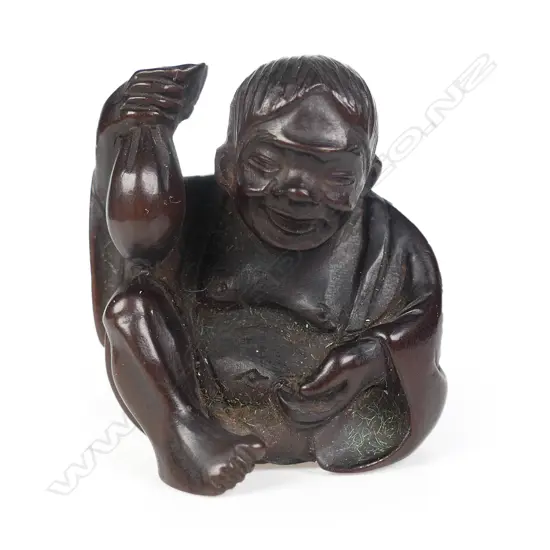 An old carved dark wood netsuke of a drunken shojo,