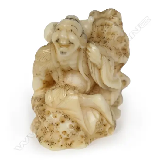 A Meiji carved walrus netsuke study of a mountain Sennin,