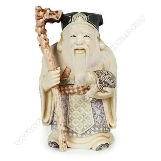 # A mid 20thC oriental solid carved ivory okimono figure of Jurojin,