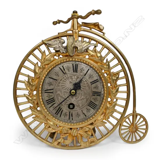 An uncommon late 19thC French gilt metal penny farthing bicycle clock,