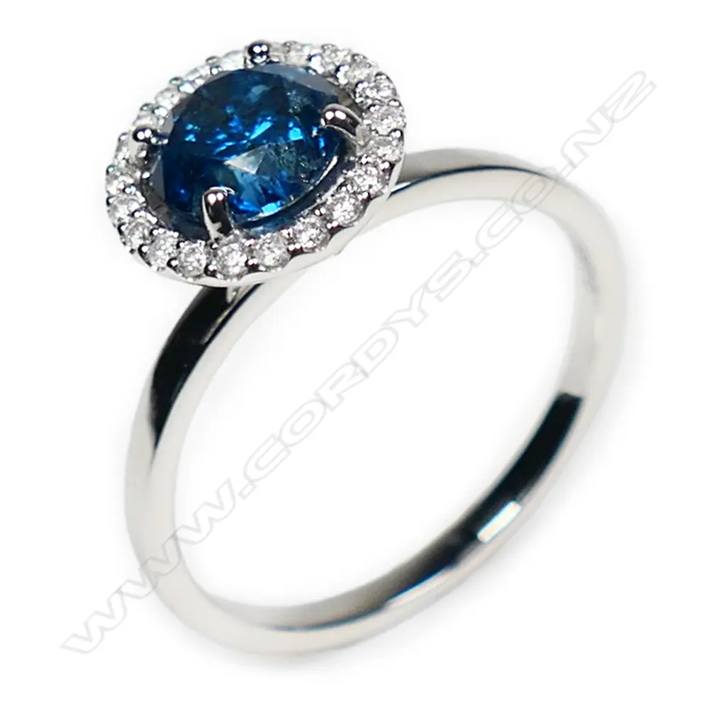 A 14ct white gold blue and white diamond halo ring, Image 1++