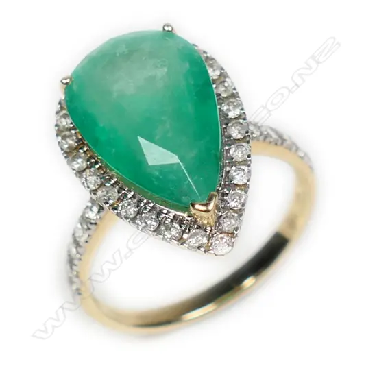 A 14ct gold Columbian emerald and diamond halo ring,