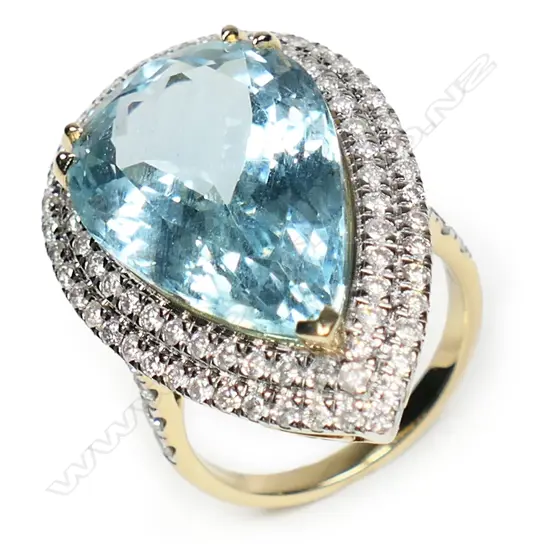 An impressive 14ct gold aquamarine and diamond double halo ring,