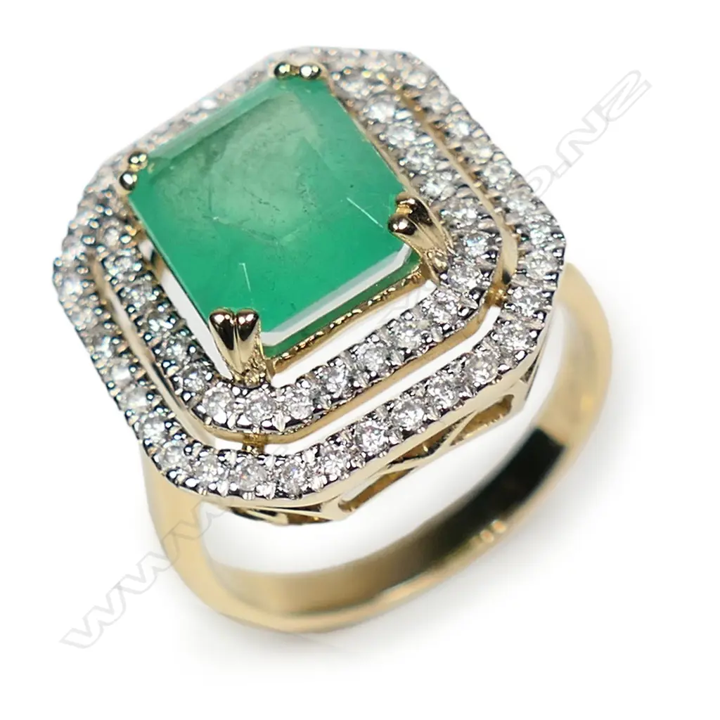 A 14ct gold Columbian emerald and diamond double halo ring Image 1++