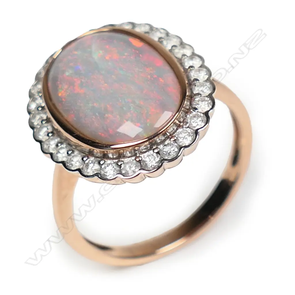 A 14ct rose gold opal and diamond halo ring, Image 1++