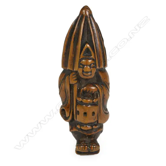 A Japanese Meiji period carved netsuke study of a man with lantern and rain parasol,