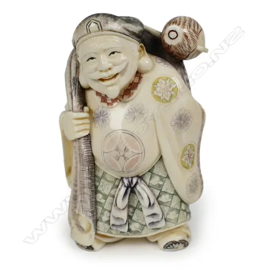 A mid 20thC oriental solid carved ivory okimono figure of Daikokuten (The God of Plenty),