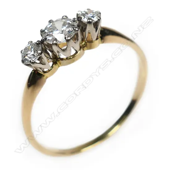 An 18ct white and yellow gold three stone diamond ring,