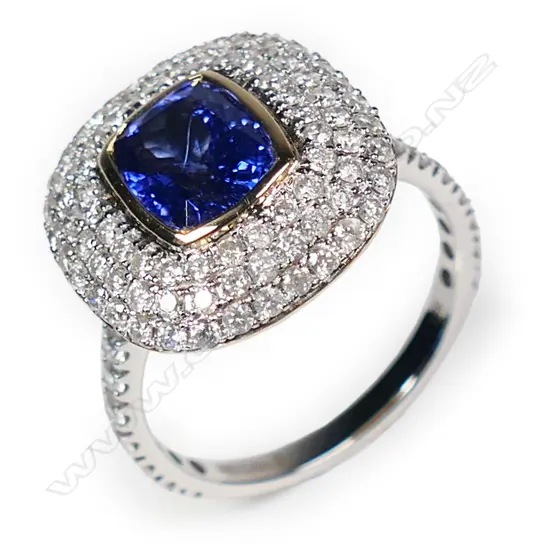 A 14ct white and yellow gold tanzanite and diamond triple halo ring,