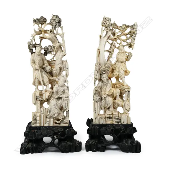 A pair of antique Chinese carved ivory figure groups,