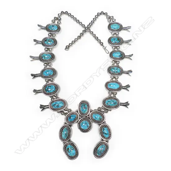 An impressive silver and turquoise Navajo style squash blossom necklace,