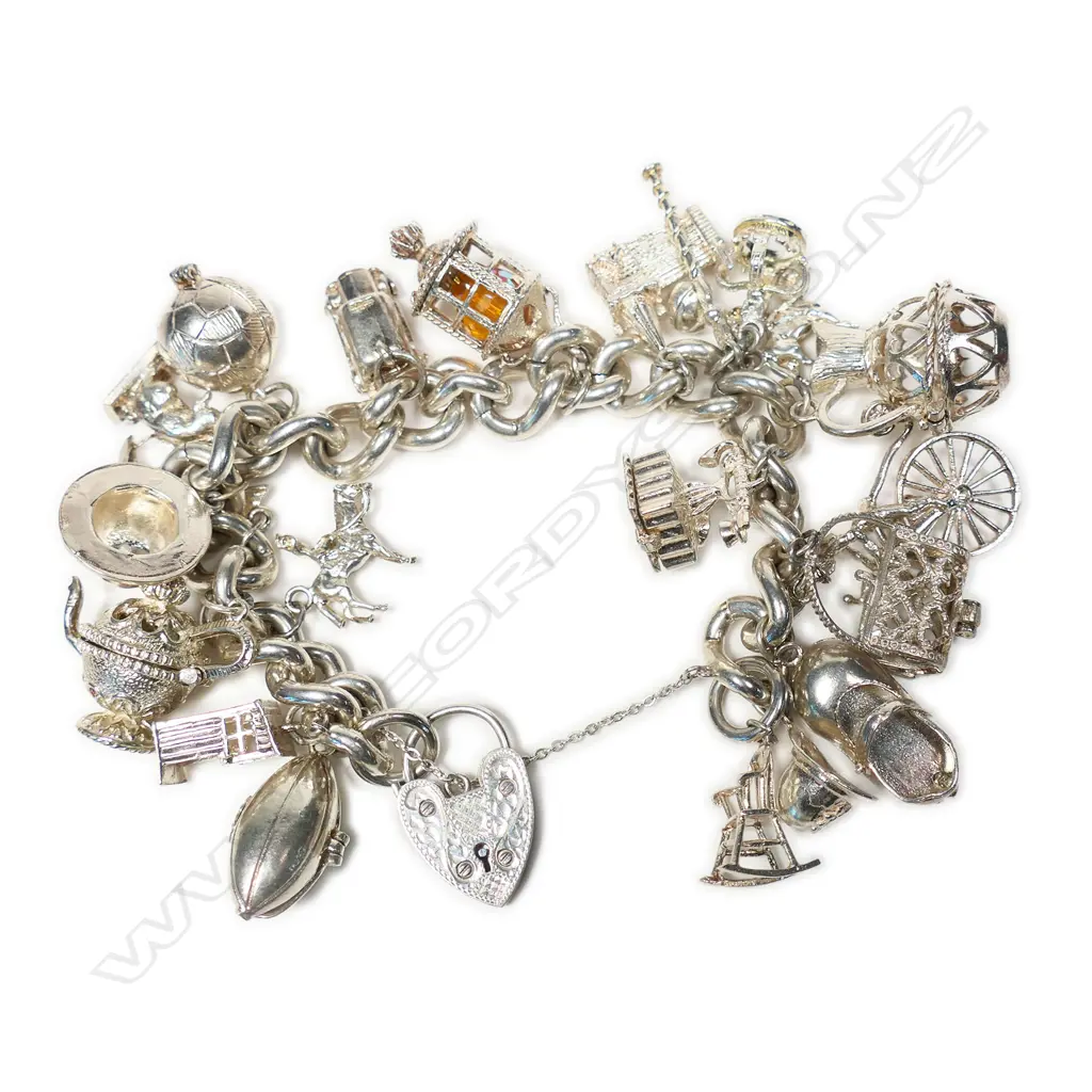 A vintage silver heavy multi charm bracelet, Image 1++
